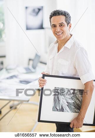 Portrait of man in his photography studio View Large Photo Image Stock Photo - Portrait of man in his photography studio. Fotosearch
