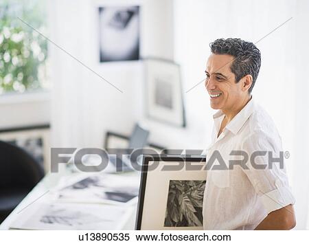 Stock Photography - Portrait of man in his photography studio. Fotosearch