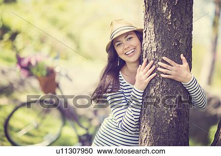 Portrait of mid adult woman embracing tree View Large Photo Image Stock Image - Portrait of mid adult woman embracing tree. Fotosearch