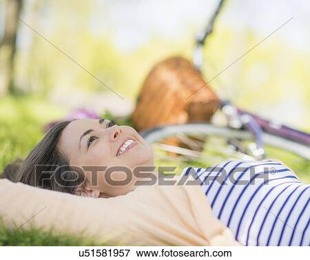 Portrait of mid adult woman relaxing in park View Large Photo Image Stock Photo - Portrait of mid adult woman relaxing in park. Fotosearch