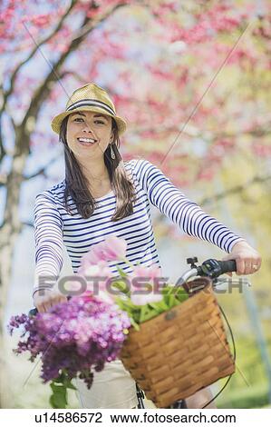 Portrait of mid adult woman riding bicycle View Large Photo Image Stock Image - Portrait of mid adult woman riding bicycle. Fotosearch