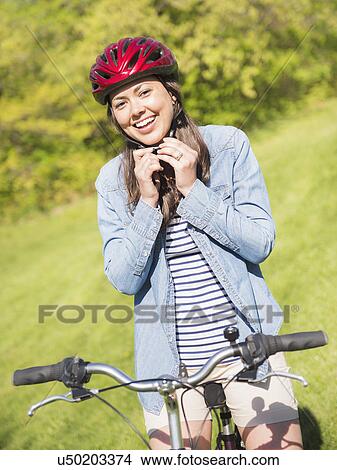 Portrait of mid adult woman with bicycle View Large Photo Image Picture - Portrait of mid adult woman with bicycle. Fotosearch