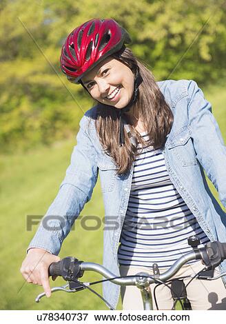 Portrait of mid adult woman with bicycle View Large Photo Image Stock Photo - Portrait of mid adult woman with bicycle. Fotosearch
