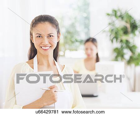 Portrait of mid adult women holding document View Large Photo Image Stock Image - Portrait of mid adult women holding document. Fotosearch