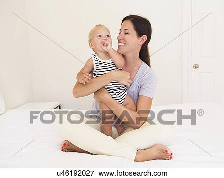 Portrait of mother with baby boy (6-11 months) View Large Photo Image Stock Photo - Portrait of mother with baby boy (6-11 months). Fotosearch