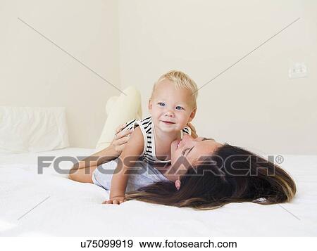 Stock Photo - Portrait of mother with baby boy (6-11 months). Fotosearch