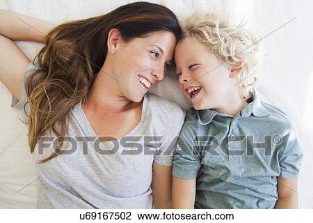 Stock Image - Portrait of mother with son (6-7). Fotosearch