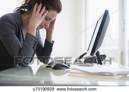 Stock Photo - Portrait of overtired woman in office. Fotosearch