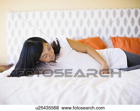 Portrait of pregnant woman laying on bed View Large Photo Image Stock Photo - Portrait of pregnant woman laying on bed. Fotosearch