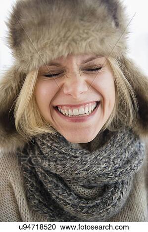 Stock Image - Portrait of smiling woman in fur hat. Fotosearch