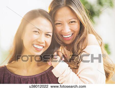 Stock Image - Portrait of smiling women. Fotosearch
