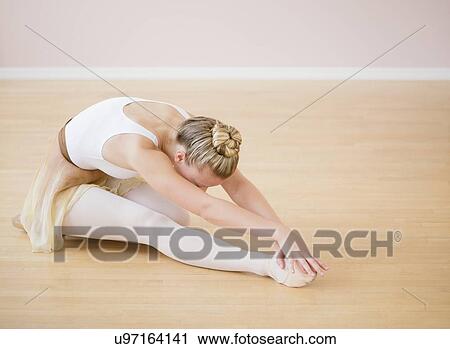 Stock Image - Portrait of teenage (16-17) ballet dancer bending over. Fotosearch
