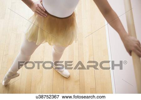 Portrait of teenage (16-17) ballet dancer standing in ballet position at barre View Large Photo Image Stock Photo - Portrait of teenage (16-17) ballet dancer standing in ballet position at barre. Fotosearch