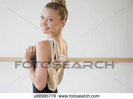 Portrait of teenage (16-17) ballet dancer holding ballet shoes View Large Photo Image Stock Photo - Portrait of teenage (16-17) ballet dancer holding ballet shoes. Fotosearch