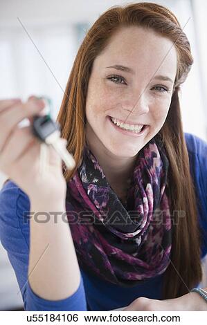Stock Photograph - Portrait of teenage girl (14-15) holding car key. Fotosearch