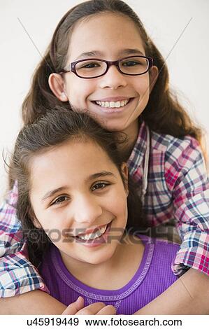 Stock Photo - Portrait of two sisters (8-9). Fotosearch