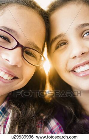 Stock Photograph - Portrait of two sisters (8-9). Fotosearch
