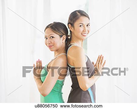 Stock Image - Portrait of two women on yoga class. Fotosearch