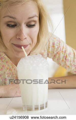 Portrait of woman blowing bubbles in milk View Large Photo Image Stock Photo - Portrait of woman blowing bubbles in milk. Fotosearch