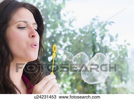 Portrait of woman blowing bubbles View Large Photo Image Stock Image - Portrait of woman blowing bubbles. Fotosearch