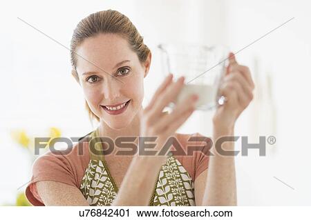 Stock Image - Portrait of woman cooking. Fotosearch