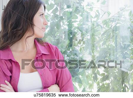 Portrait of woman looking out window View Large Photo Image Stock Photography - Portrait of woman looking out window. Fotosearch