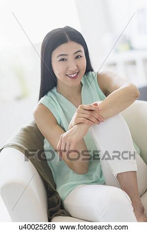 Portrait of woman sitting in armchair View Large Photo Image Stock Photo - Portrait of woman sitting in armchair. Fotosearch