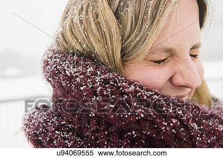 Stock Photography - Portrait of woman wearing wooly scarf. Fotosearch