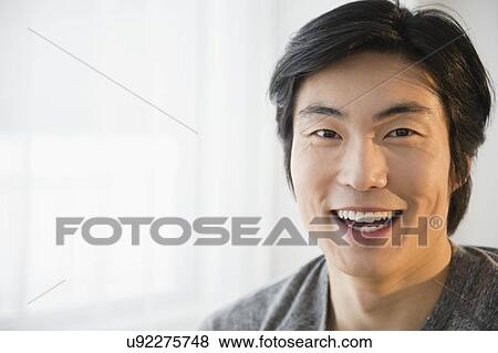 Portrait of young man smiling View Large Photo Image Stock Photo - Portrait of young man smiling. Fotosearch
