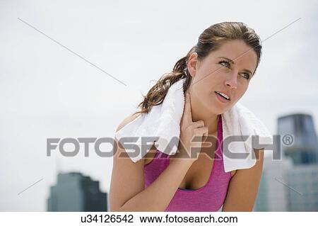 Portrait of young woman checking her pulse View Large Photo Image Stock Image - Portrait of young woman checking her pulse. Fotosearch