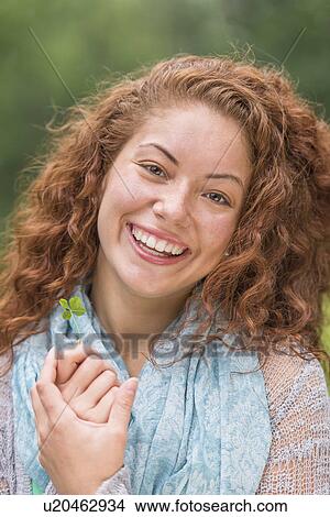Portrait of young woman in park View Large Photo Image Picture - Portrait of young woman in park. Fotosearch
