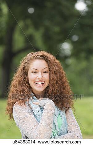 Portrait of young woman in park View Large Photo Image Picture - Portrait of young woman in park. Fotosearch
