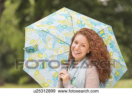 Portrait of young woman in park View Large Photo Image Stock Photo - Portrait of young woman in park. Fotosearch
