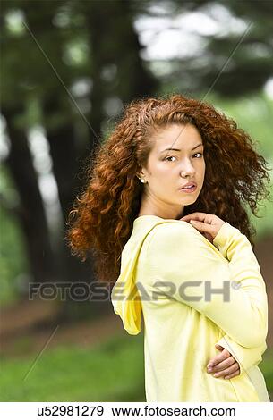 Portrait of young woman in park View Large Photo Image Stock Photo - Portrait of young woman in park. Fotosearch
