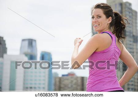 Portrait of young woman jogging View Large Photo Image Stock Photo - Portrait of young woman jogging. Fotosearch
