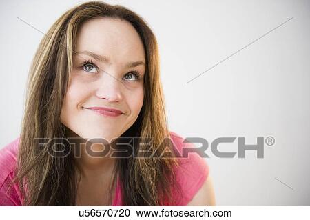 Stock Image - Portrait of young woman smiling. Fotosearch
