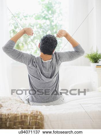 Stock Photo - Rear view of mature man stretching. Fotosearch