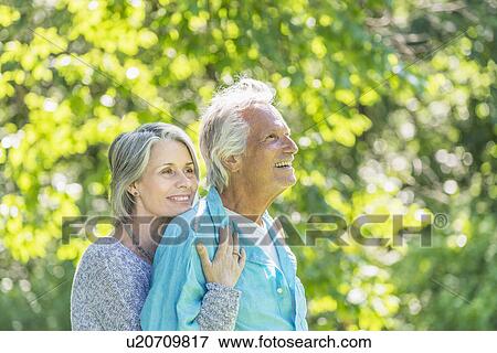 Senior couple embracing in park View Large Photo Image Stock Photo - Senior couple embracing in park. Fotosearch
