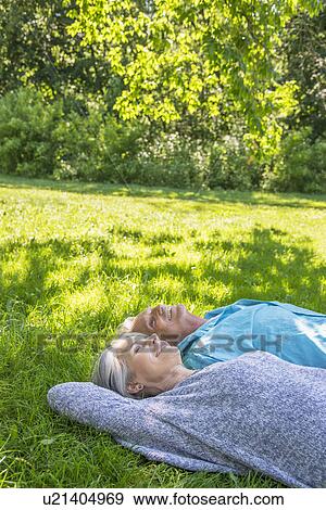 Senior couple relaxing in park View Large Photo Image Stock Photo - Senior couple relaxing in park. Fotosearch