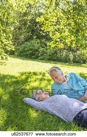 Senior couple relaxing in park View Large Photo Image Stock Photo - Senior couple relaxing in park. Fotosearch
