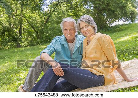 Senior couple relaxing in park View Large Photo Image Stock Photo - Senior couple relaxing in park. Fotosearch