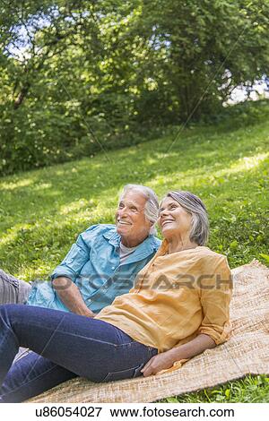 Senior couple relaxing in park View Large Photo Image Stock Photo - Senior couple relaxing in park. Fotosearch