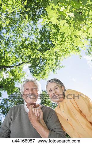 Stock Photo - Senior couple under trees. Fotosearch