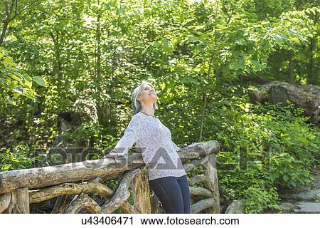 Senior woman relaxing in park View Large Photo Image Stock Image - Senior woman relaxing in park. Fotosearch