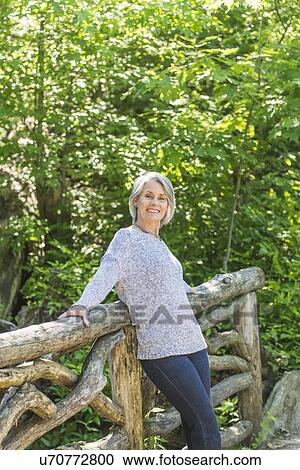 Senior woman relaxing in park View Large Photo Image Stock Image - Senior woman relaxing in park. Fotosearch