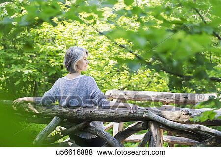Stock Photo - Senior woman relaxing in park. Fotosearch