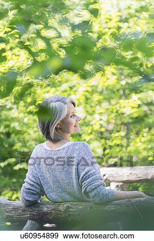 Senior woman relaxing in park View Large Photo Image Stock Photo - Senior woman relaxing in park. Fotosearch