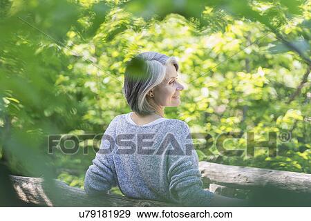 Stock Photo - Senior woman relaxing in park. Fotosearch