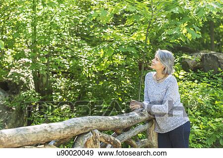 Stock Photo - Senior woman relaxing in park. Fotosearch