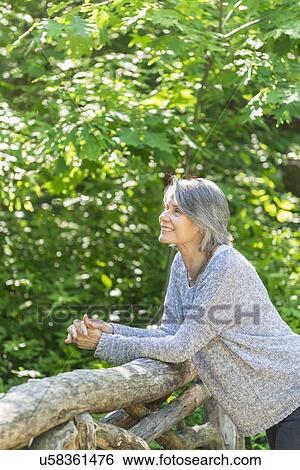 Senior woman relaxing in park View Large Photo Image Stock Photograph - Senior woman relaxing in park. Fotosearch